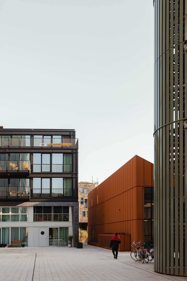 The Corten steel warehouse office building seen along an alley