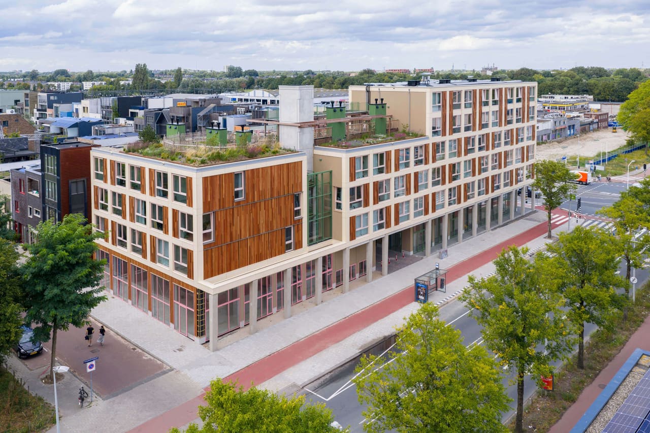 Aerial view of Poppies in Amsterdam-Noord: a timber-clad residential block with roof gardens in its neighbourhood